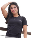Woman in athletic wear posing against a white background