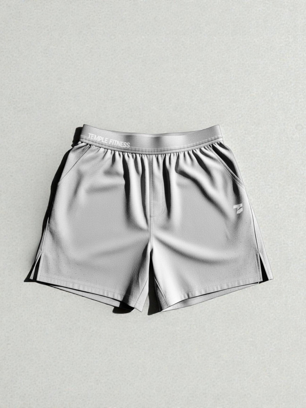Silver shorts with a brand logo on a light gray background